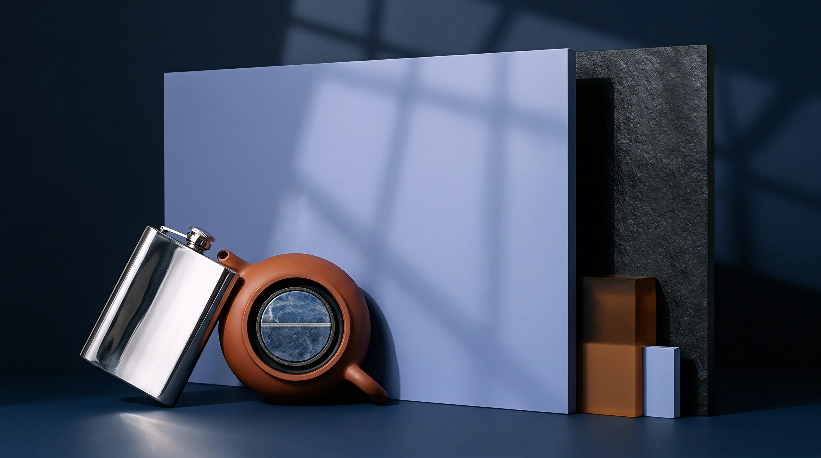 A metallic flask and a rounded clay object with a glass viewer are staged with material samples and industrial blocks.